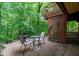 Outdoor patio with a water fountain, table, chairs, and mature trees at 3813 N Ramsgate Rd, Martinsville, IN 46151
