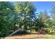 Playground with swings and slides, surrounded by mature trees and lush landscaping at 3813 N Ramsgate Rd, Martinsville, IN 46151