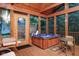Enclosed sunroom featuring a hot tub, wood ceiling, screened windows and an outdoor view at 3813 N Ramsgate Rd, Martinsville, IN 46151