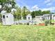 A partially obscured view of the backyard features a fenced in pool, green grass, sheds and some plantings at 4096 N 200 W, Greenfield, IN 46140
