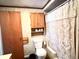 A full bathroom featuring a toilet, a bathtub with a curtain, and a wall cabinet at 4096 N 200 W, Greenfield, IN 46140