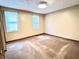 A simple bedroom with two windows and neutral-colored walls and flooring at 4096 N 200 W, Greenfield, IN 46140