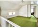 Spacious bonus room featuring vintage green carpeting, white walls and ceiling, a double window and white trim at 4096 N 200 W, Greenfield, IN 46140