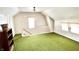 A carpeted bonus room featuring vintage green carpeting, white walls and ceiling, a double window and white trim at 4096 N 200 W, Greenfield, IN 46140