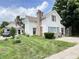 Charming two-story home with blue shutters, brick chimney, and covered side porch, set on a green lawn at 4096 N 200 W, Greenfield, IN 46140