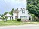 Charming two-story home with blue shutters, brick chimney, and covered side porch, set on a green lawn at 4096 N 200 W, Greenfield, IN 46140