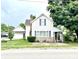 Charming two-story home features a brick chimney, front porch, and lush landscaping, set on a green lawn at 4096 N 200 W, Greenfield, IN 46140