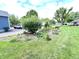 Well-maintained front yard with lush grass, a landscaped flower bed, and a glimpse of a parked car at 4096 N 200 W, Greenfield, IN 46140