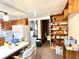 This full kitchen view shows wood cabinets, a white refrigerator, and a shelving system at 4096 N 200 W, Greenfield, IN 46140