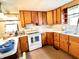 Efficient kitchen with white appliances, laminate countertops, and wood cabinets, perfect for cooking and storage at 4096 N 200 W, Greenfield, IN 46140