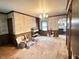 A spacious carpeted room with patterned wallpaper and a view into the kitchen at 4096 N 200 W, Greenfield, IN 46140