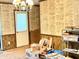 A carpeted room with patterned wallpaper and items ready to be packed in boxes at 4096 N 200 W, Greenfield, IN 46140