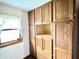 Wall of wood cabinets and drawers offering ample storage space, with window letting in natural light at 4096 N 200 W, Greenfield, IN 46140
