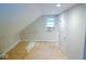 An attic featuring a window with an AC unit and access door at 4219 Mathews Ave, Indianapolis, IN 46227