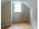 Attic with a window, wood paneling and carpeted floor at 4219 Mathews Ave, Indianapolis, IN 46227