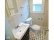 Traditional bathroom featuring black and white tiled floor and classic fixtures at 4219 Mathews Ave, Indianapolis, IN 46227