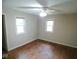 A bedroom showcasing hardwood floors, two windows, and neutral wall paint at 4219 Mathews Ave, Indianapolis, IN 46227
