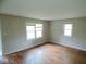 Well-lit bedroom with hardwood floors, multiple windows, and fresh paint at 4219 Mathews Ave, Indianapolis, IN 46227