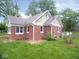 Brick home with a gabled roof, trimmed windows and green lawn at 4219 Mathews Ave, Indianapolis, IN 46227