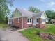 Side view of brick home with well-maintained lawn, showcasing the home's architecture at 4219 Mathews Ave, Indianapolis, IN 46227