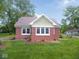 Charming brick home featuring a gabled roof, trimmed windows and a well manicured front lawn at 4219 Mathews Ave, Indianapolis, IN 46227