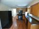 Functional kitchen with wooden cabinets, updated appliances, and vinyl flooring at 4219 Mathews Ave, Indianapolis, IN 46227