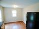 Kitchen area with modern black refrigerator, laminate flooring, natural light and an adjacent doorway at 4219 Mathews Ave, Indianapolis, IN 46227