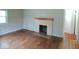 Living room featuring a classic fireplace, hardwood floors, and an adjacent doorway at 4219 Mathews Ave, Indianapolis, IN 46227