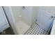 A tiled shower stall with white interior and tiled floor at 4219 Mathews Ave, Indianapolis, IN 46227
