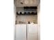 Well-organized laundry room with a modern washer and dryer, plus storage shelves at 5704 Carrousel Dr, Indianapolis, IN 46254