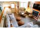 Comfortable living room featuring stylish decor, wood floors, fireplace, and an egg chair at 5704 Carrousel Dr, Indianapolis, IN 46254