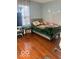 Bright bedroom featuring wood floors, a comfortable bed, and mountain-themed decor on the walls at 6334 Winslow Dr, Indianapolis, IN 46237