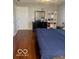 Clean bedroom with laminate floors, neutral wall paint and a bedroom set with dark wood accents at 6334 Winslow Dr, Indianapolis, IN 46237