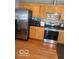 The kitchen offers stainless steel appliances, updated cabinets, granite counters and backsplash at 6334 Winslow Dr, Indianapolis, IN 46237