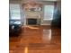 Spacious living room featuring a cozy fireplace, hardwood floors, and natural light at 6334 Winslow Dr, Indianapolis, IN 46237