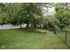 Large, grassy backyard featuring a combination of privacy fence and mature trees at 643 Harlan St, Plainfield, IN 46168