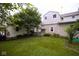 Spacious backyard with green grass and shade trees and shrubs at 643 Harlan St, Plainfield, IN 46168