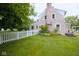 Well-maintained backyard with a white picket fence and lush landscaping at 643 Harlan St, Plainfield, IN 46168