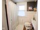 Small bathroom featuring a shower with decorative curtains, toilet and artwork at 643 Harlan St, Plainfield, IN 46168