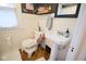 Small bathroom featuring a pedestal sink, toilet, and decorative accessories at 643 Harlan St, Plainfield, IN 46168