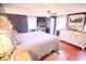 This is a charming bedroom featuring hardwood floors and a ceiling fan at 643 Harlan St, Plainfield, IN 46168