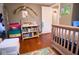 Bright bedroom features wood floors, natural light, and a whimsical dinosaur decor at 643 Harlan St, Plainfield, IN 46168