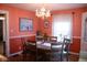Dining room with warm lighting, a wooden table, and coral-colored walls at 643 Harlan St, Plainfield, IN 46168