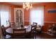 Dining room with a round wooden table, decorative lighting, and large windows with lace curtains at 643 Harlan St, Plainfield, IN 46168