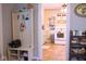 Cozy entryway with coat rack and shoe storage, leading into a kitchen with white appliances at 643 Harlan St, Plainfield, IN 46168