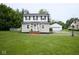 Charming two-story home featuring a well-maintained lawn, white picket fence, and detached garage at 643 Harlan St, Plainfield, IN 46168