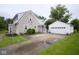 Exterior view of home with detached garage and large driveway providing ample parking space at 643 Harlan St, Plainfield, IN 46168