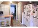 Eat-in kitchen featuring tile flooring, a refrigerator covered in photos, and bright lighting at 643 Harlan St, Plainfield, IN 46168