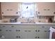 Updated kitchen with a double basin sink, ample cabinet space, and bright, natural lighting at 643 Harlan St, Plainfield, IN 46168