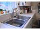 Kitchen sink with a window overlooking the yard, potted plants, and lots of counter space at 643 Harlan St, Plainfield, IN 46168